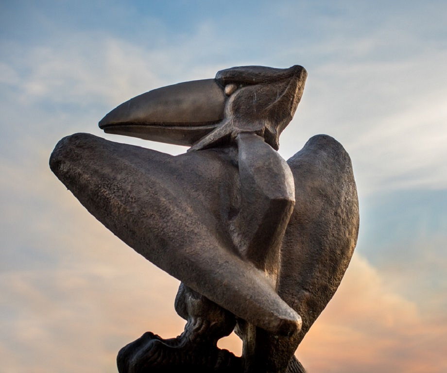 Jayhawk statue against sunset